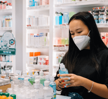 woman in pharmacy holding bottle